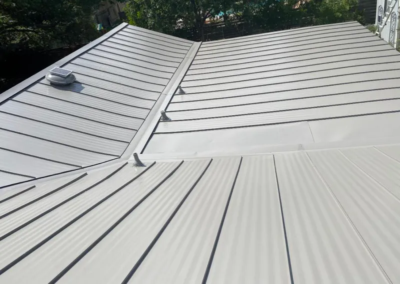 Solar attic fan installed on a metal roof for Roof Ventilation in Bondurant